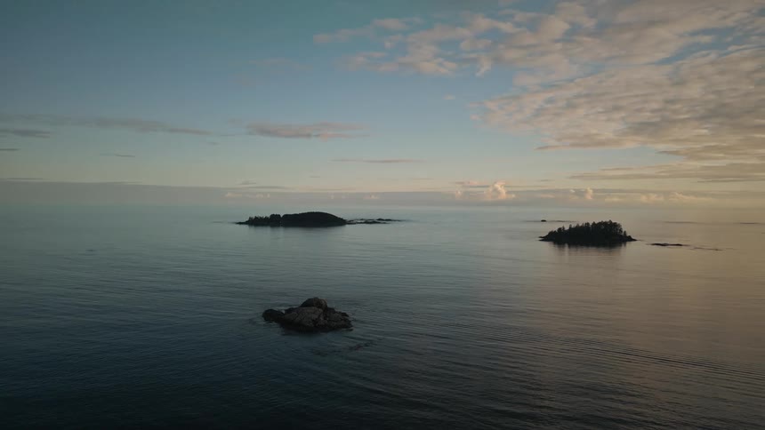 Silhouette of small islands in the ocean at sunset