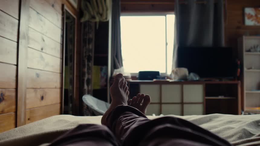 Feet of a person lying in bed