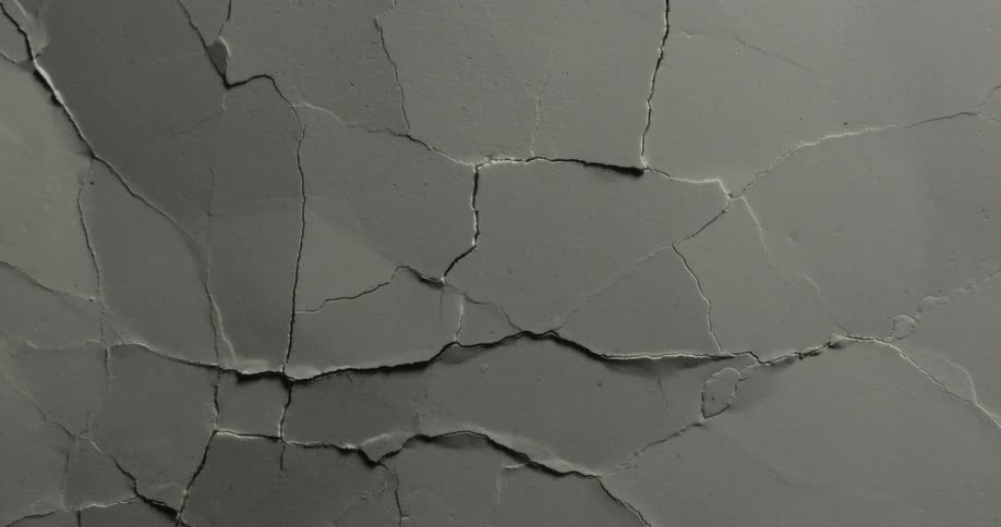 Movement breaks and cracks a gray surface