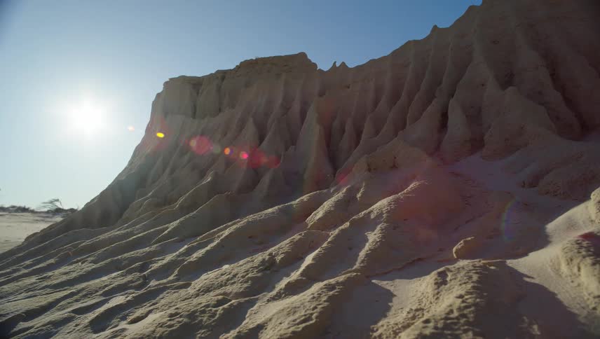 Sun behind a desert sand dune