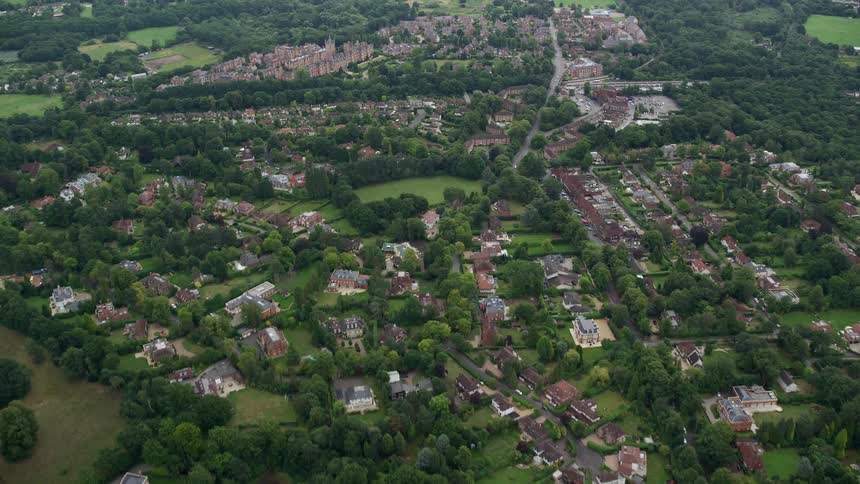 Aerial view of an urban area surrounded by green spaces