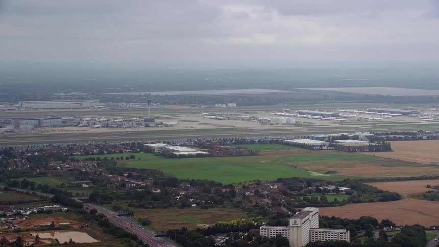 Aerial view of suburban area and airport filled with planes