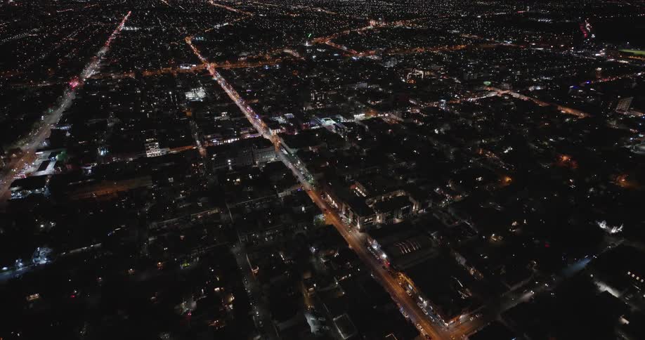 Aerial view of a city streets with cars at night