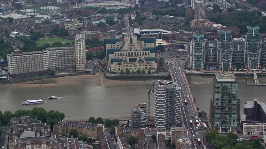 Aerial view of a metropolis on the edge of a lake with bridges buildings and vehicles