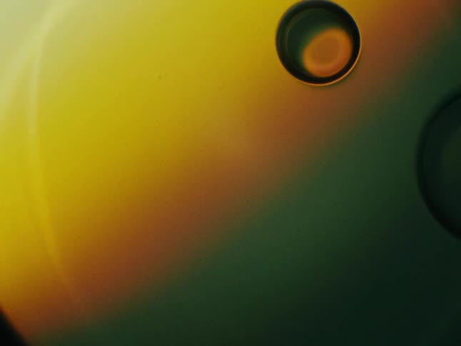 Two bubbles being approached on an orange and green background