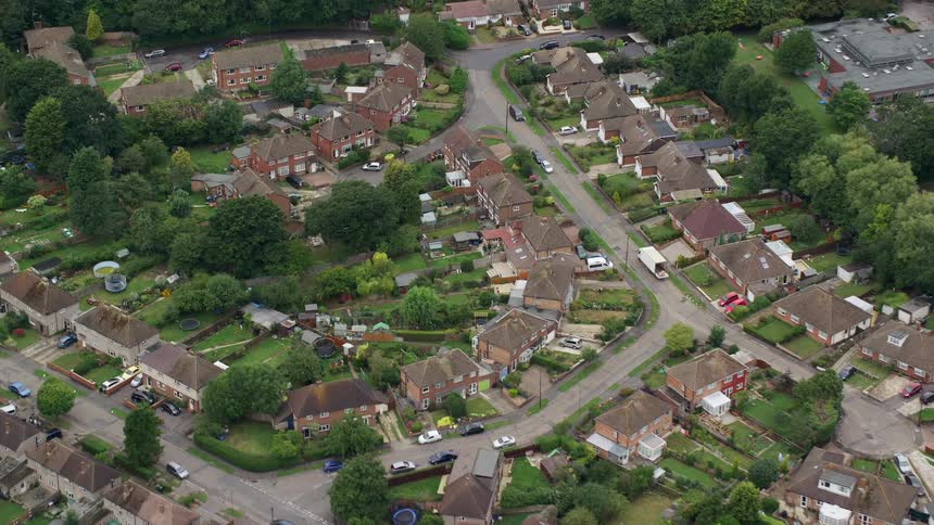 Highway separates field from residential neighborhood