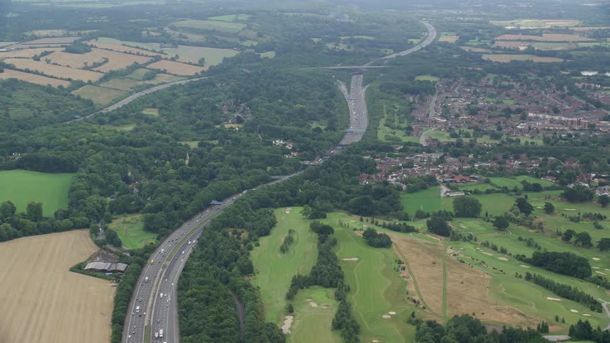 Aerial view of a road with vehicles amid rural and agricultural areas