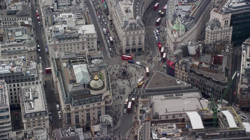 Aerial view of a metropolitan city with vehicles and people passing by