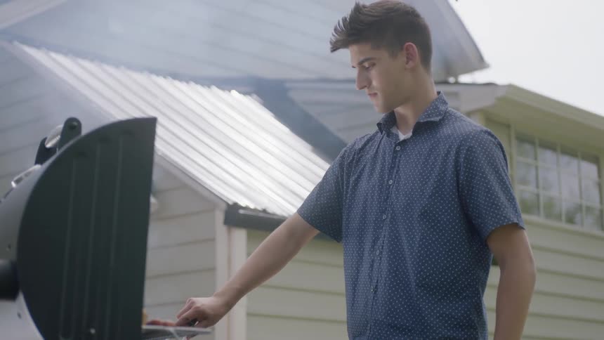 A man is cooking on a barbecue
