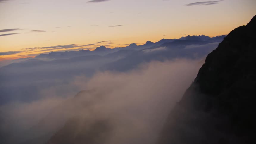 View of mountains amidst the clouds on a morning