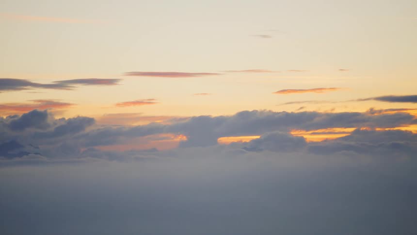 View from above as the golden sky reflects on the clouds