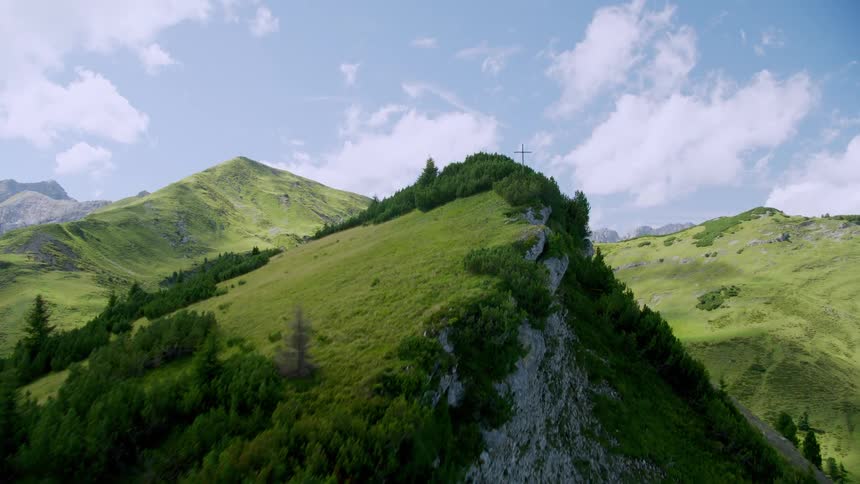 The mountains are green with some trees