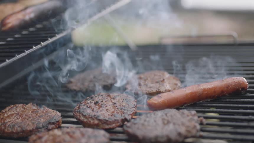 Burgers are cooking on the barbecue