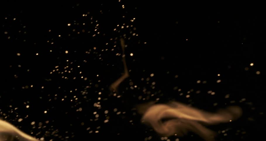 Many particles of fire sparks on a black background