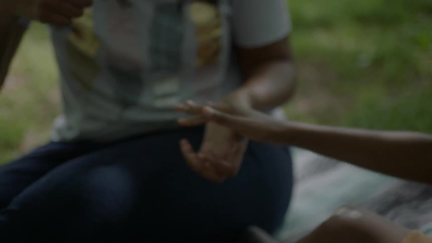 A woman and child play games with their hands