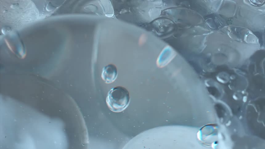 A clear blue liquid with several bubbles
