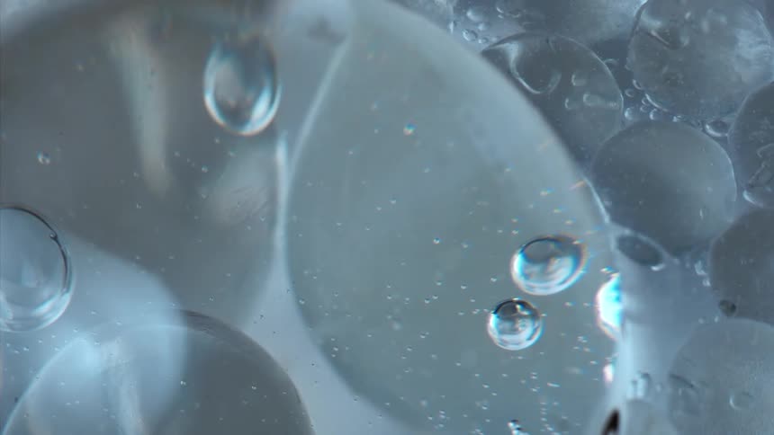 Air bubbles floating on a clear liquid