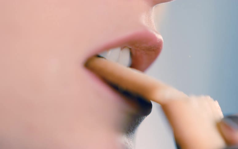 A woman bites a cookie