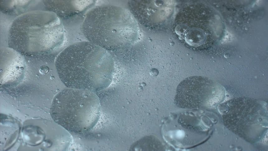 A clear blue liquid bubbling