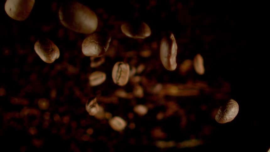 Roasted coffee grains falling