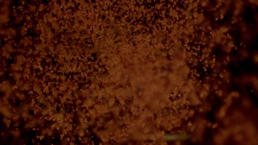 Roasted ground coffee falls down