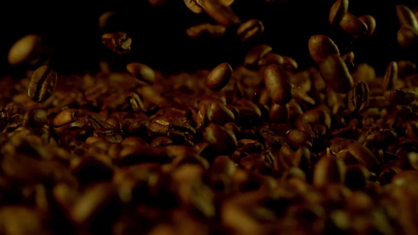 Roasted coffee grains falling