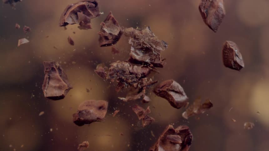 A coffee bean exploding into many smaller parts