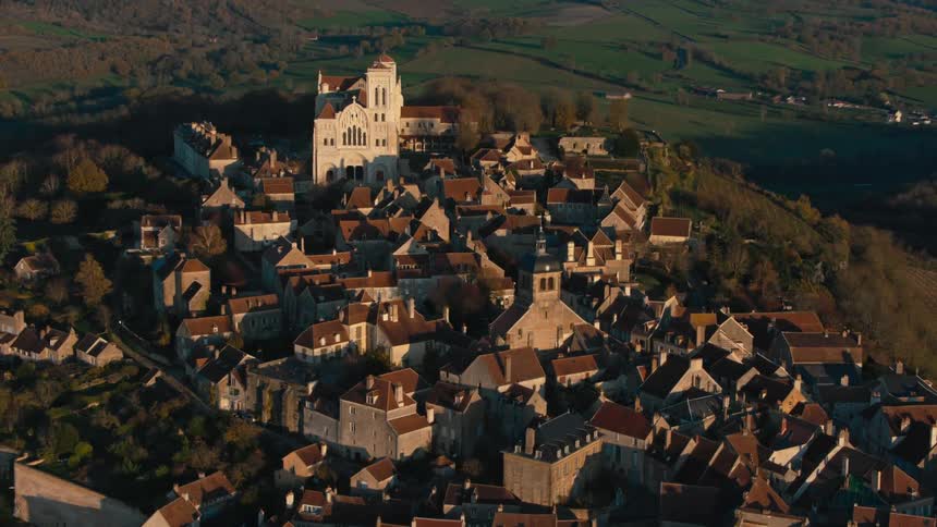Town surrounds castle on hill overlooking valley containing rural villages