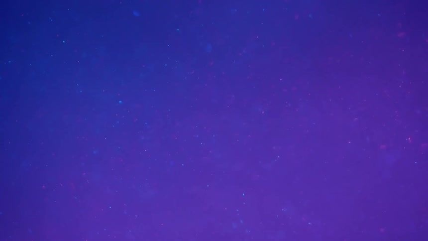 Floating sparkling metallic particles with neon lighting background