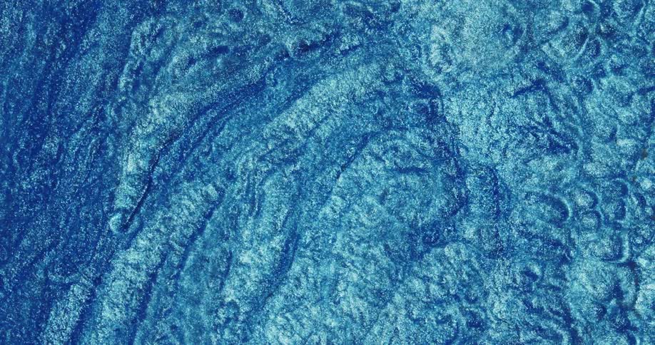 Abstract fluid texture of flowing sparkling metallic glitter