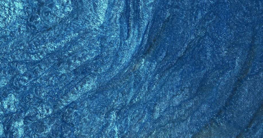 Abstract fluid texture of flowing sparkling metallic glitter