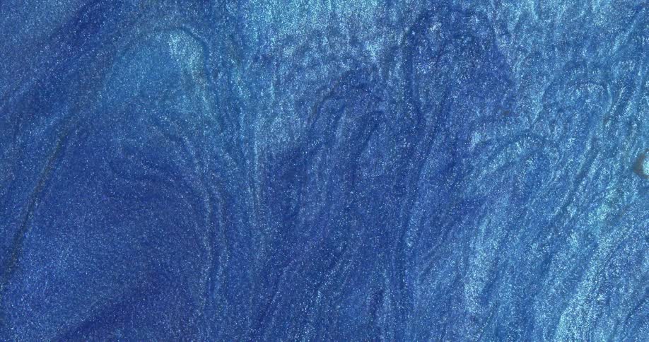 Abstract fluid texture of flowing sparkling metallic glitter