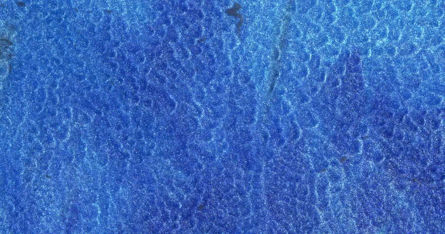 Abstract fluid texture of flowing sparkling metallic glitter