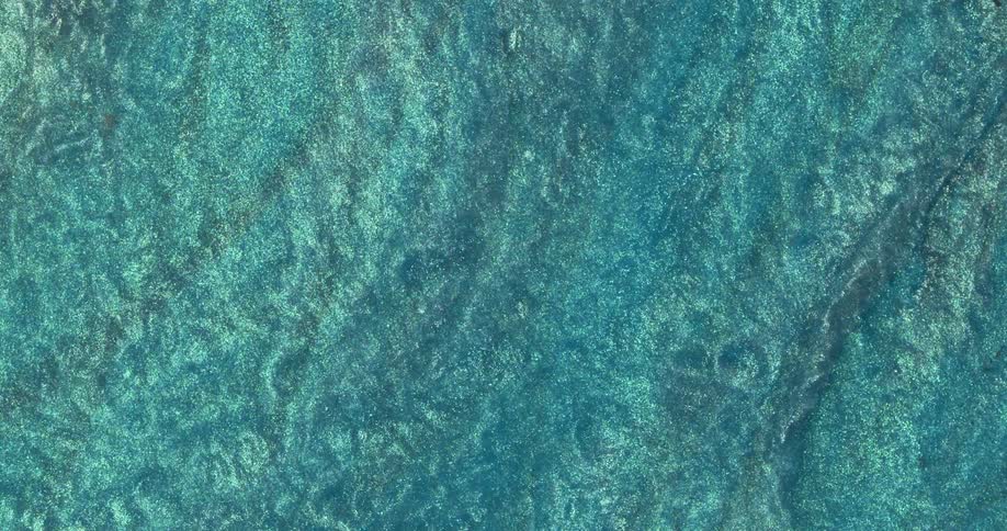 Macro close up of swirling metallic shimmer inks