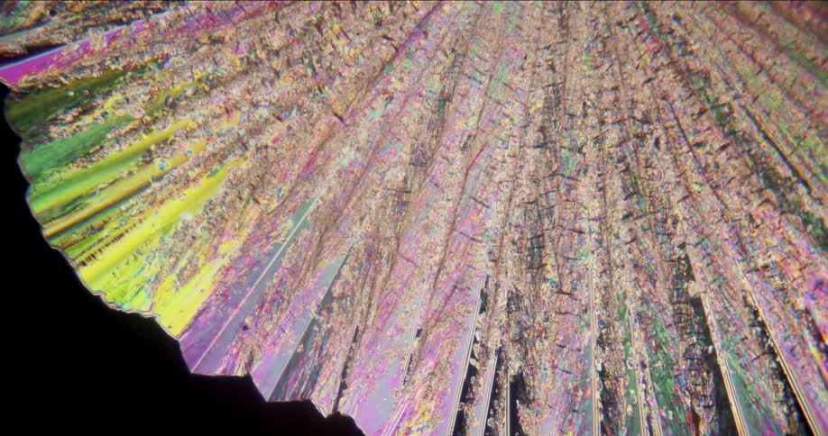 Growing colorful crystals forming under a microscopic small view