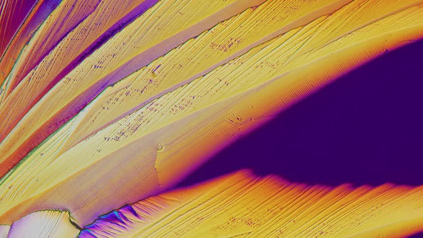 Abstract patterns of crystals from salicylic acid under microscope