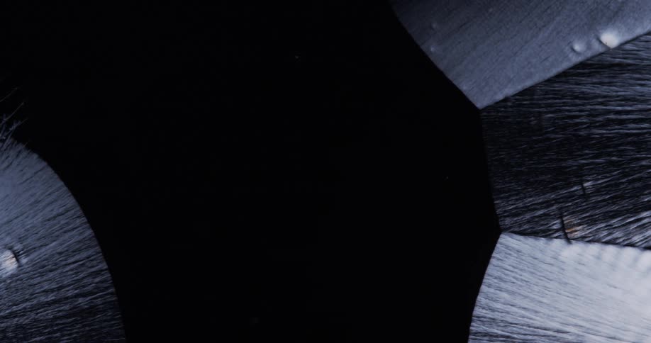 Microscope view of growing liquid crystals on black background