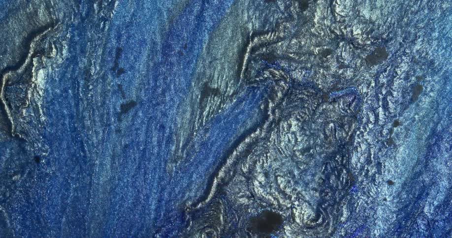 Flowing abstract liquid glitter inks with shiny reflecting particles