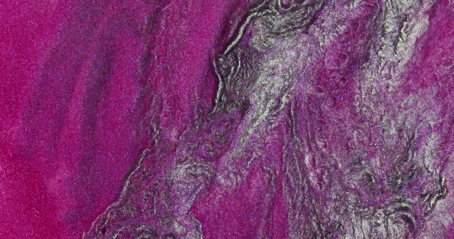 Iridescent shimmering metallic glitter inks flowing in abstract shapes