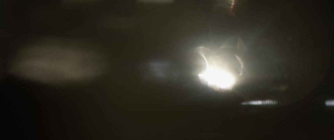 Light glares into dark interior through openings in surface