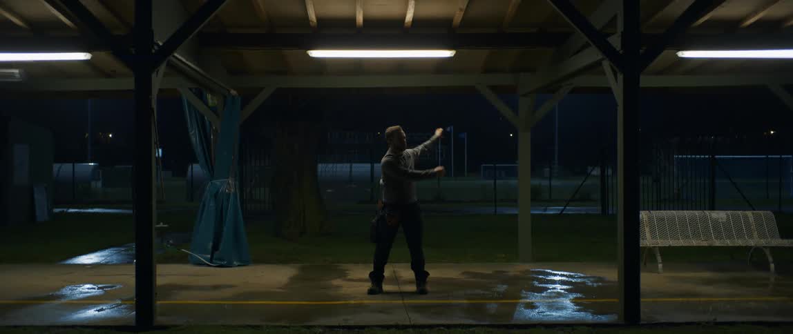 A man is swinging his arms back and forth on the platform