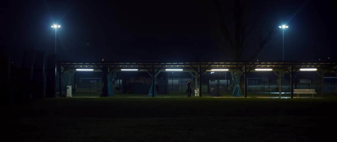 A man is very far away standing near turnstiles