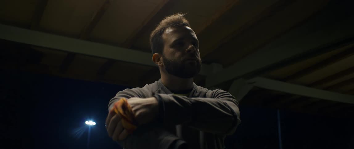 A man holds his elbow and repeatedly moves his forearm up and down