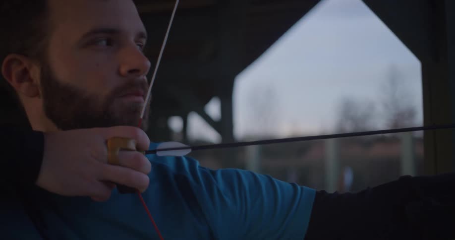 A man aims his bow