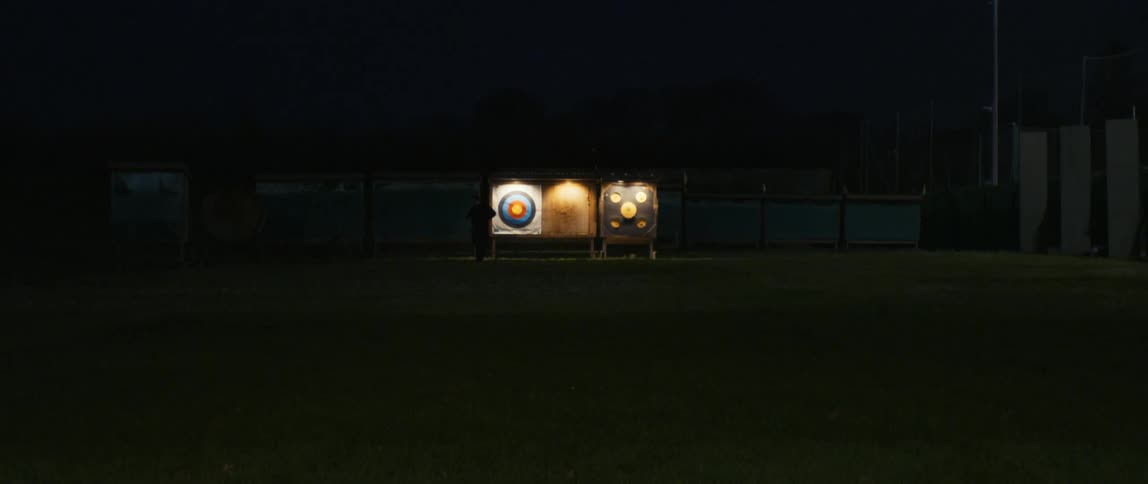 View of three archery targets at night