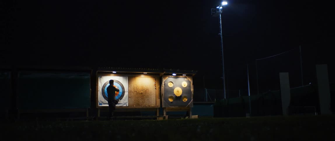 Person removing arrows from the target board