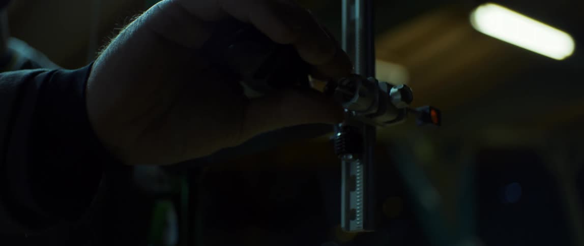 Archer assembles a bow at night
