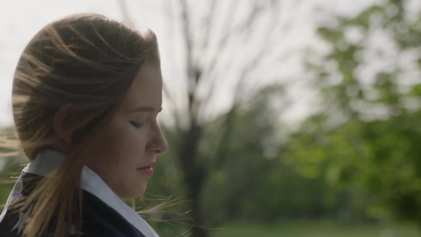 A woman hair blows in the wind on a sunny day