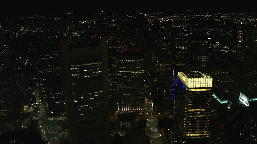 A city with huge buildings on a night where the apartments have lights on