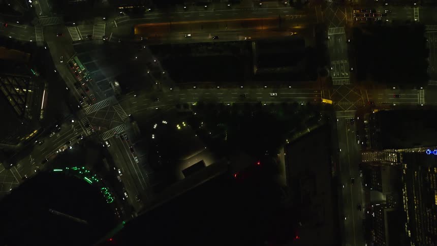 Aerial view of city streets and buildings at night